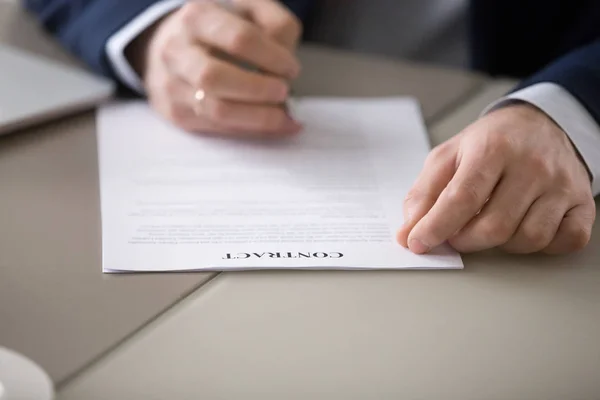 Close up of male CEO put signature on business contract