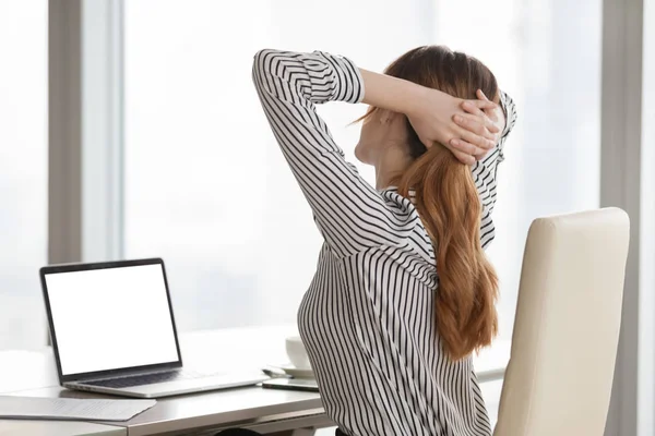 Businesswoman stretching in chair tired after long work at lapto — Stock Photo, Image