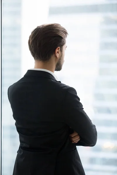 Thoughtful male worker plan future projects looking in window — Stock Photo, Image