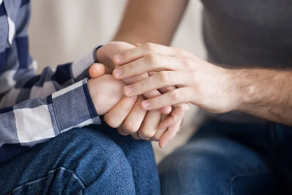 Close up of couple holding hands reconciled after fight