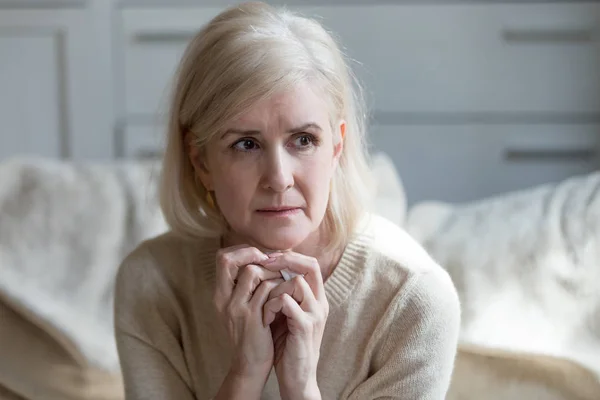 Thoughtful upset mature lady crying thinking of loneliness or gr — Stock Photo, Image