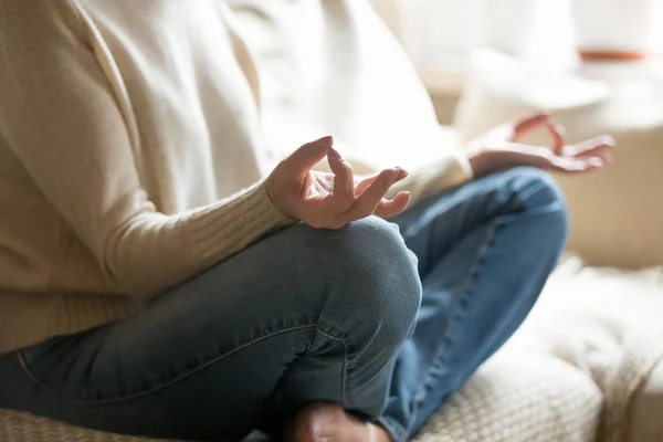 Senior woman holding hands in mudra practicing home yoga, closeu — Stock Photo, Image