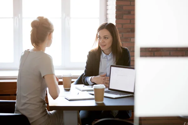 Friendly young businesswomen talking chatting in office during c — Stock Photo, Image