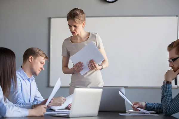 Serious female leader discussing results reading financial repor — Stock Photo, Image