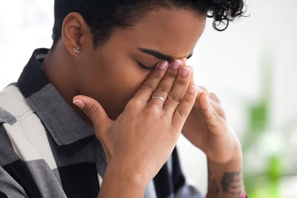 Upset black businesswoman feels unwell sitting in office