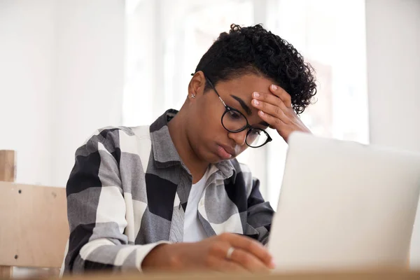 Femme américaine bouleversée assis travaillant à l'aide d'un ordinateur portable dans le bureau — Photo