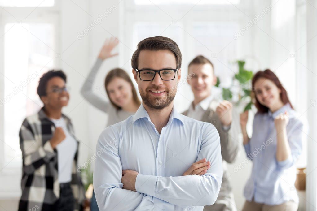 Confident businessman with group of multiracial business people 