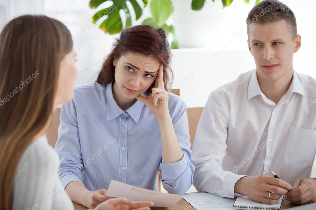 Three person sitting at the desk in office during interview