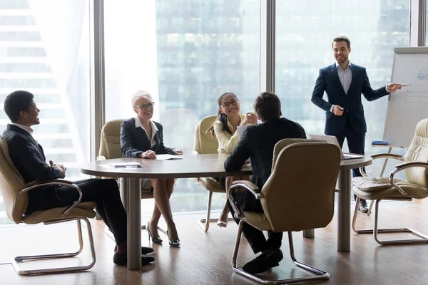 Male employee make presentation at friendly office meeting