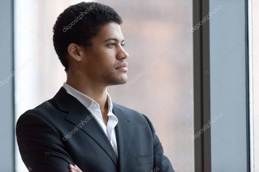 Thoughtful black businessman dreaming of business success