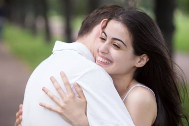 Young attractive couple in love embracing outdoors clipart