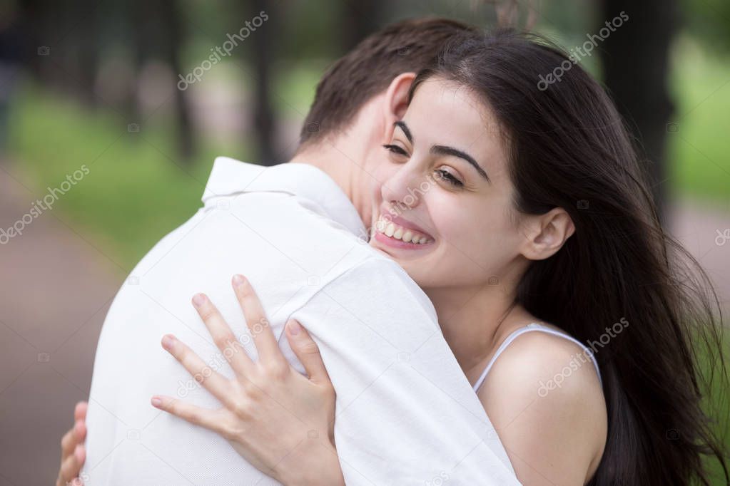 Young attractive couple in love embracing outdoors