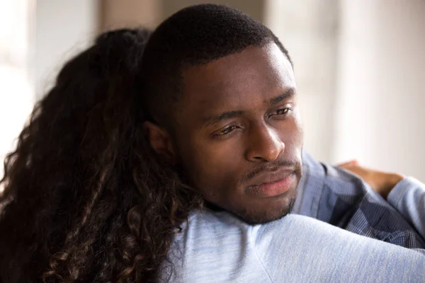 Black African woman embracing sad frustrated man — Stock Photo, Image