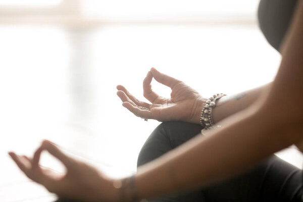 Female fingers in mudra gesture meditation pose