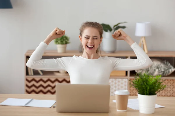 Excited woman feels happy sitting at the desk — Stock Photo, Image