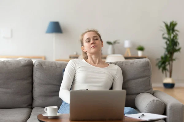 Young woman sitting on couch and sleeping — Stock Photo, Image