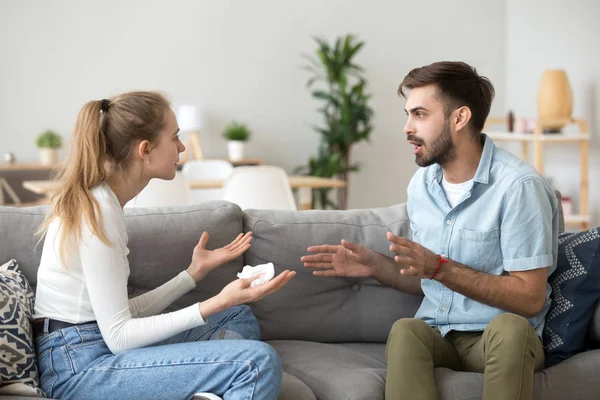 Coupe emotivamente discutendo seduto sul divano a casa — Foto Stock