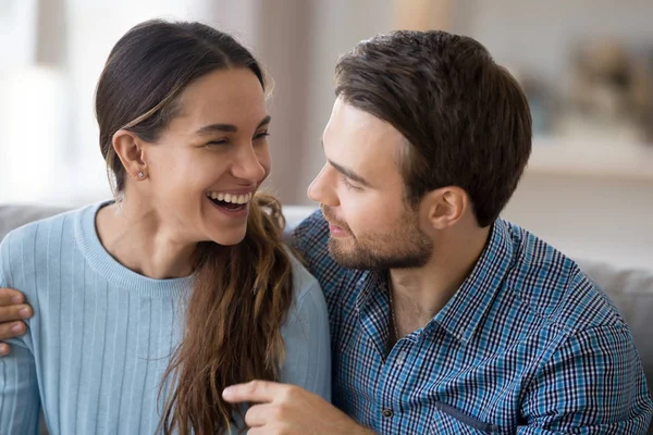 Couple in love talking laughing sitting on couch — Stock Photo, Image