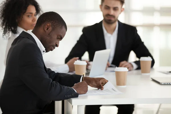 African American employee sign business contract at meeting