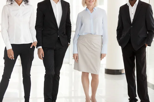 Legs of diverse work managers posing in office hallway — Stock Photo, Image