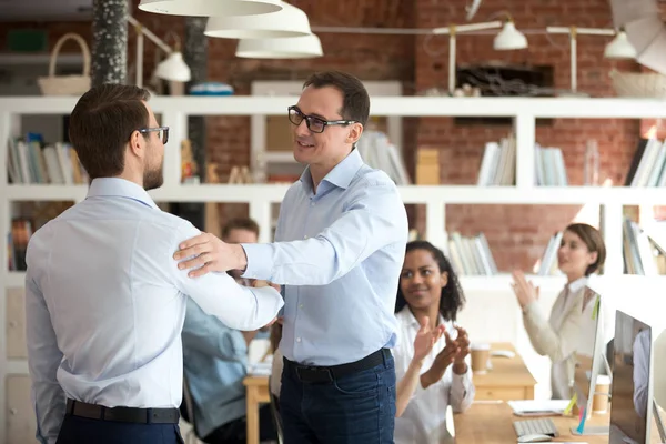 Businessman handshake male employee greeting with promotion — Stock Photo, Image