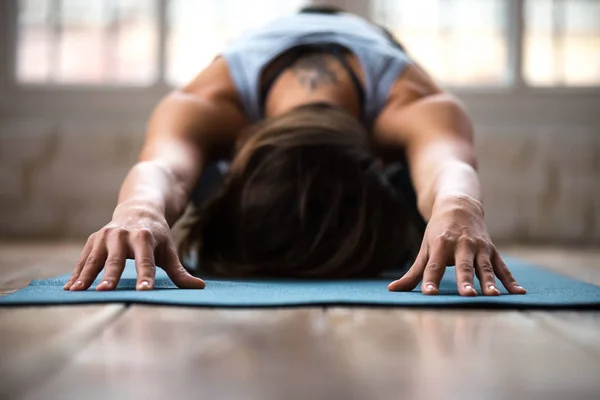 Young sporty woman practicing yoga, doing Child exercise, close — Stock Photo, Image