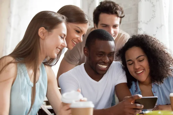 Happy diverse students using smartphone takes a selfie