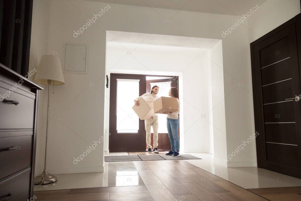 Couple arrived at new house with cardboard boxes