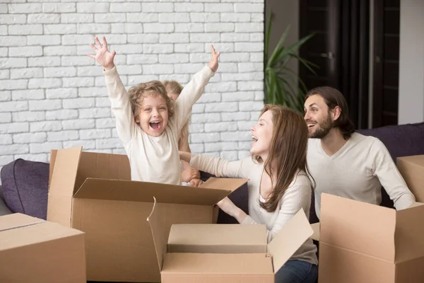 Happy family with cardboard boxes at their new home — Stock Photo, Image