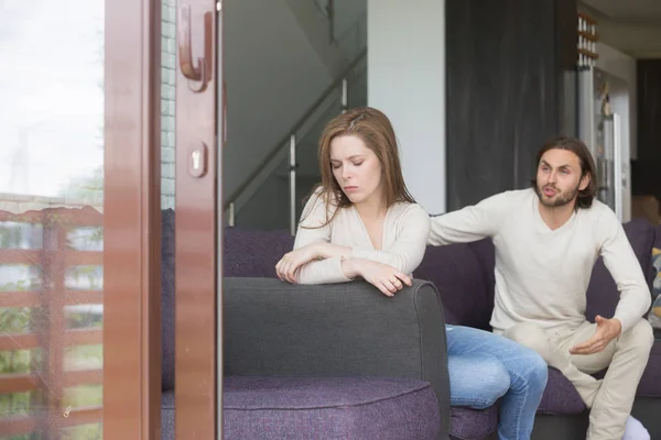 Young man and woman quarreling at home — Stock Photo, Image