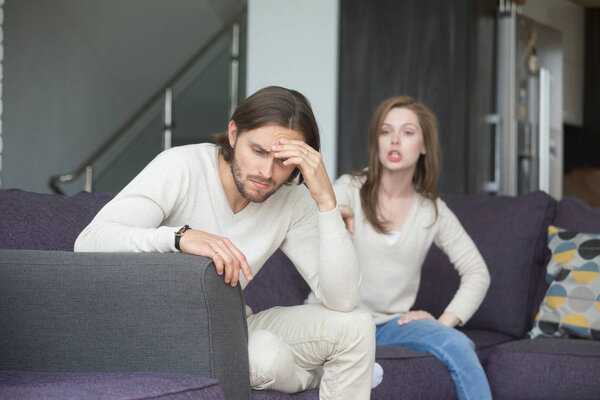 Young man and woman quarreling at home