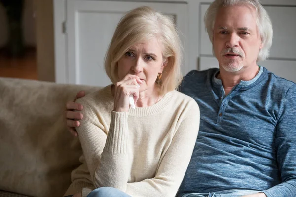 Emotional senior couple get nervous watching TV drama at home — Stock Photo, Image