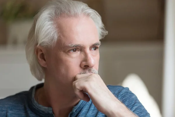 Thoughtful aged man looking in distance lost in thoughts — Stock Photo, Image