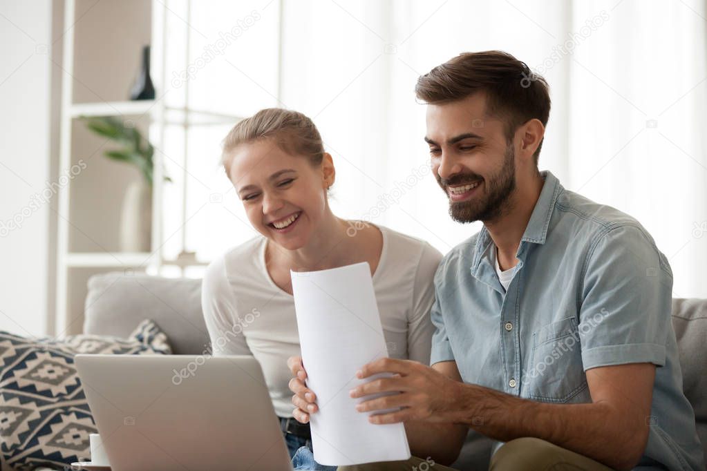 Happy husband and wife excited receiving positive bank notice
