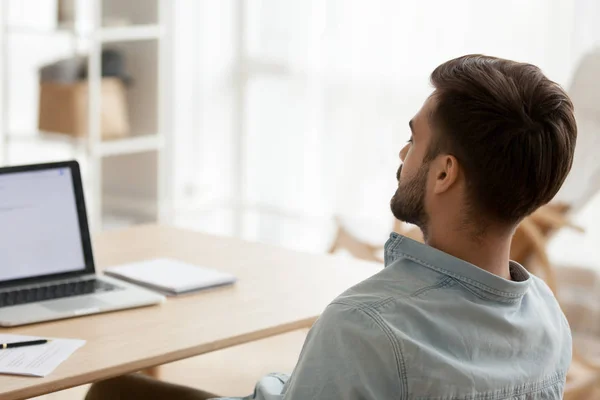 Back view of tired male falling asleep at workplace — Stock Photo, Image