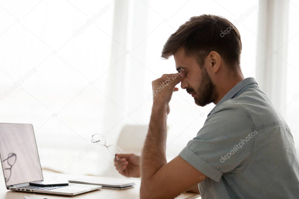 Tired man feel unwell suffering from headache