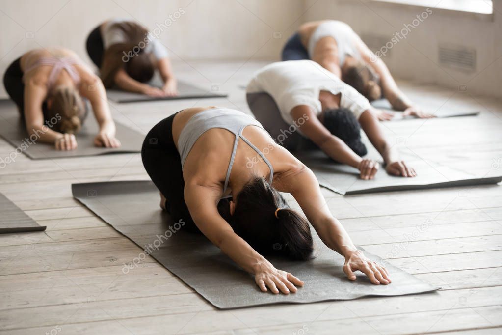 Group of young sporty people practicing yoga lesson, Child exerc
