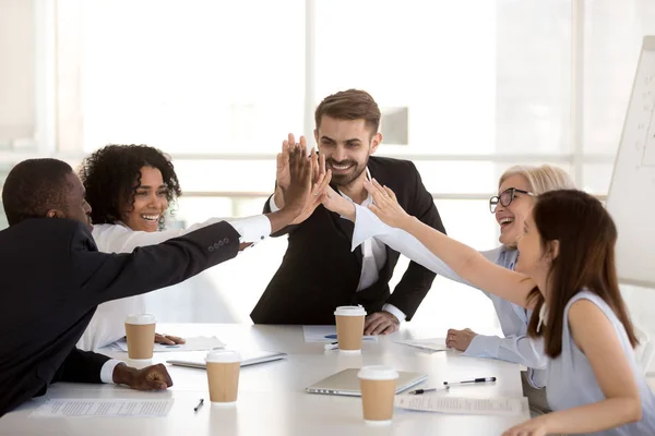 Happy motivated diverse business team people giving high five