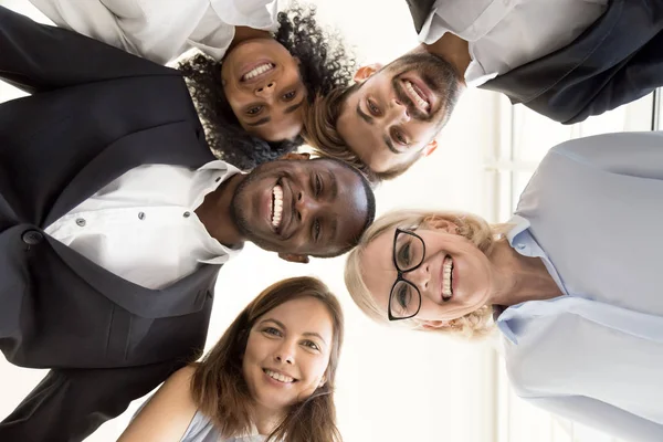 Happy diverse business team gathering in circle looking at camer — Stock Photo, Image