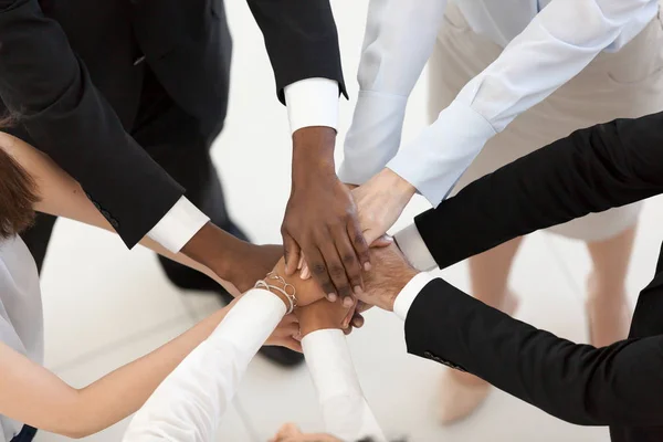 Diverse business people put hands together in pile, top view — Stock Photo, Image