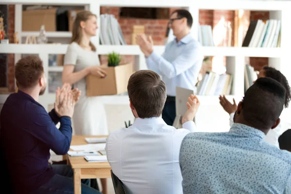 Team leader with colleagues applauding to just hired employee