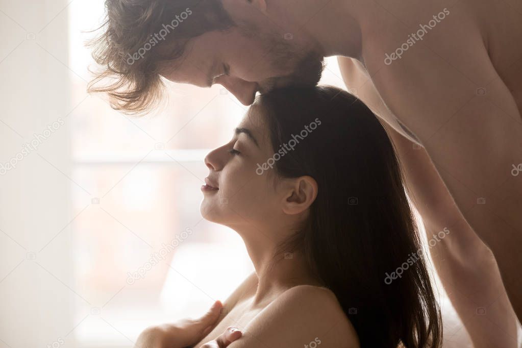 Passionate boyfriend kiss girlfriend head during foreplay