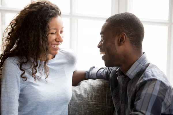 Smiling African American couple in love sitting together