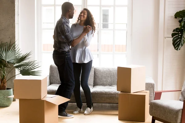 Happy African American couple dancing after moving — Stock Photo, Image