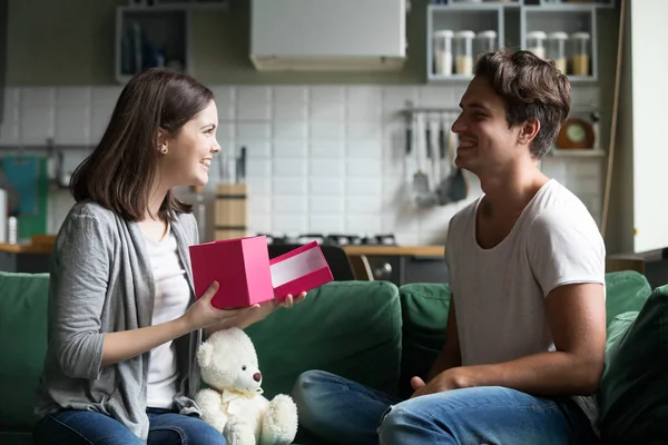 Young man gave to beloved girl a gift — Stock Photo, Image