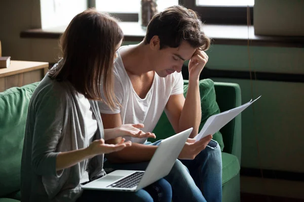 Stressed young couple argue about bills at home — Stock Photo, Image