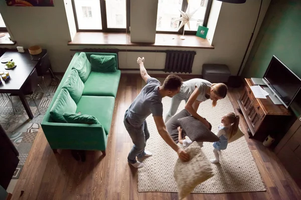 Joven familia jugando almohadas lucha con hijo e hija — Foto de Stock