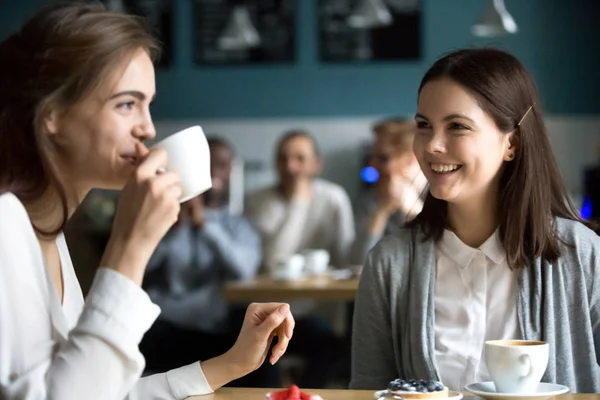 Pretty girls having fun in cafe drinking coffee — Stock Photo, Image