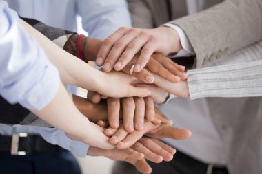 Close up of diverse people put hands in stack clipart