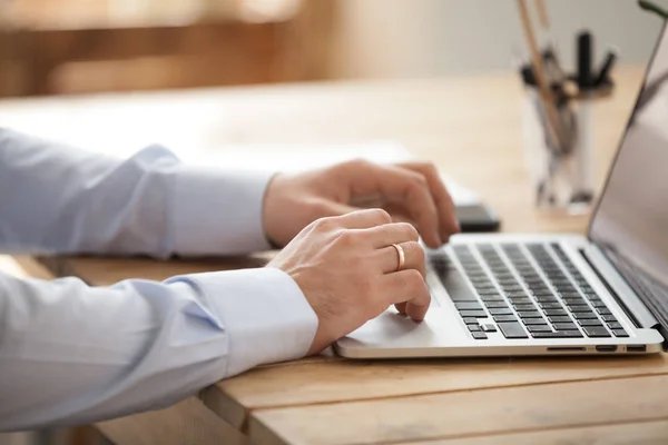 Close up of businessman using laptop browsing internet — Stock Photo, Image